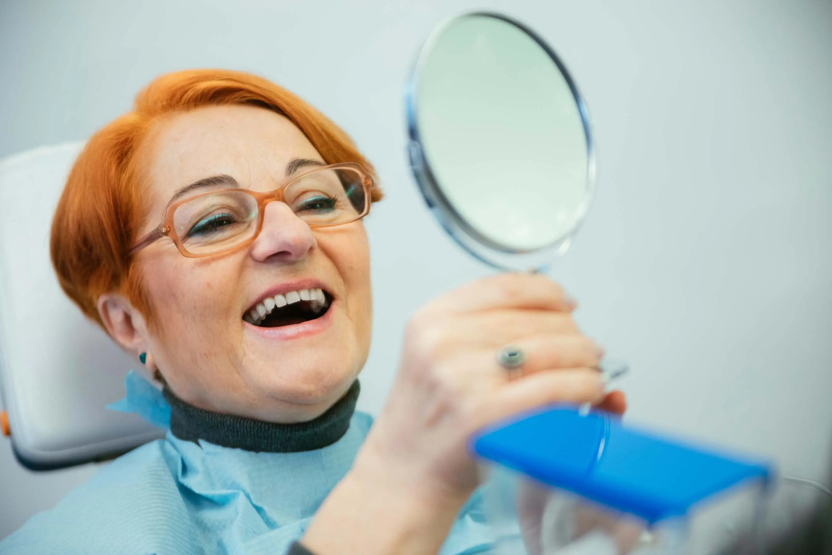 Portrait of a beautiful brunette girl who smiles brushes her teeth and holds a tooth retainer on a yellow background. Dentistry. Advertising. Orthodontist. Place for an inscription.by Diana Polekhina
